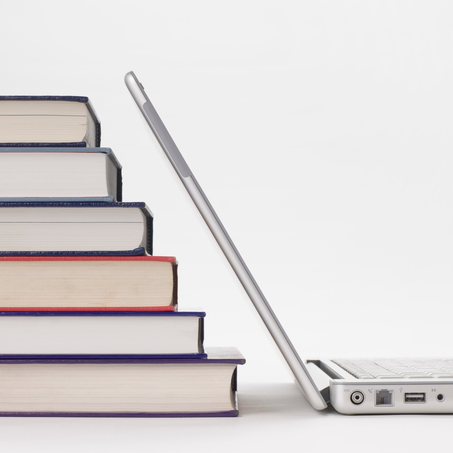Stack of books and laptop computer